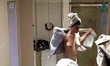 showering brunette showcases her beautiful pale breasts on cam