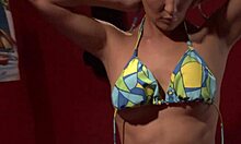 Dark-haired babe in a revealing bikini shows off her butt