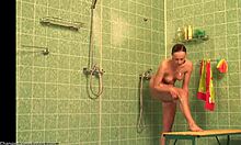 flexible long-legged beauty spreads legs wide to shave pussy in hidden shower cam