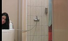 Sexy brunette sneaks into tub with a hung guy