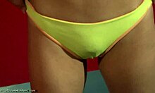 This tempting blonde is undressing and watching herself through the mirror