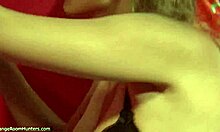 This tempting blonde is undressing and watching herself through the mirror