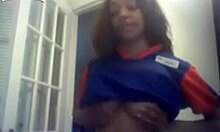 Curly-haired ebony hottie flashing her big tits on cam