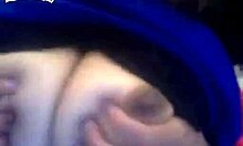 Curly-haired ebony hottie flashing her big tits on cam