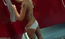 spy on this hot blonde changing and fixing herself up in the mirror.