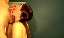 Pigtailed brunette kneels to suck massive cock close-up