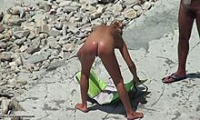 Tanned blonde girlfriend shows hot body on beach