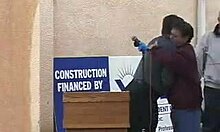 Naked redhead anchorwoman flaunts her tits in front of the camera