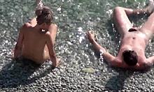 Naked blonde shows perky ass on rocky beach