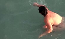 Hey, check my dark-haired chubby girlfriend skinny dipping at nudist beach! 🏖️