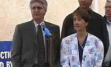 Naked redhead anchorwoman flaunts her tits in front of the camera