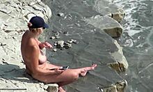 Smoking hot chick lights up another cigarette while soaking in the stunning beach vibes