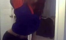 Curly-haired ebony hottie flashing her big tits on cam