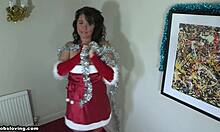 Christmas celebration with tanned brunette in Santa outfit