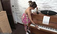 Striped Stockings Brunette Struggles to Move Piano While Flashing Topless Boobs