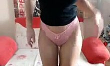 Blonde camgirl teases with pink panties on sofa