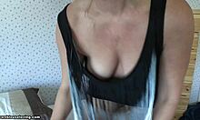 mature blonde wife poses in bedroom, showing big tits with wavy hair