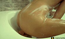 Soapy naked hottie fucks her crack in the bathtub