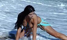 Tanned brunette poses big tits naked on beach