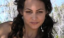 Tanned Brunette Reveals Her Big Boobs on a Sunny Beach.