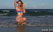 blond beauty flaunts tight body on sunny beach shore