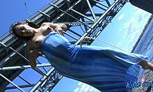 busty babe in a sexy flowing dress shows her naked pregnant body outdoors