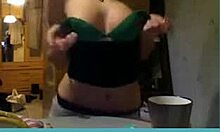 short-haired blonde milf strips on webcam, showing her tits.