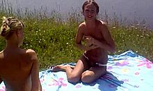 Look at these two slutty girlfriends sunbathing topless on the beach!