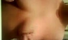 Amateur with impressive breasts trying to hide them on webcam