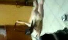 Seductive drunk amateur performs striptease in bar.