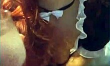 Stockings-clad redhead pleasures herself in an office chair