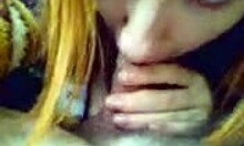 Redheaded minx intriguingly blows big cock in POV car scene on cam.