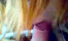 Redheaded minx intriguingly blows big cock in POV car scene on cam.