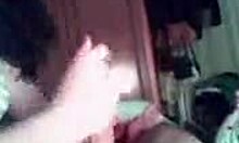 Brunette wife boldly blows and strokes cock like a professional in homemade scene.