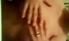 Amateur with impressive breasts trying to hide them on webcam