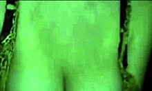 Russian mature amateur flashes big tits in dark striptease.