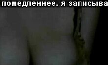 Russian mature amateur flashes big tits in dark striptease.