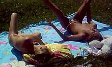 Look at these two slutty girlfriends sunbathing topless on the beach!