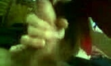 Dark-haired amateur in red sucks uncut cock suggestively.