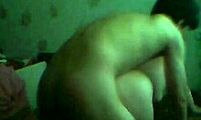 Brown-haired girlfriend chats on webcam in bedroom.