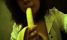 Dark-Haired Teen GF Sucks Banana Naughtily with Small Tits