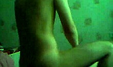 Brown-haired girlfriend chats on webcam in bedroom.