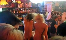 Two blondes perform hot striptease and dance in public bar