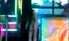 Brunette amateur strips naked and dances wildly on the night club stage