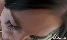 Lusty brunette gives passionate blowjob on bed.