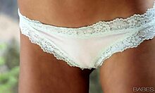 Lauren Clare fingers her shaved pussy alone, moaning softly.