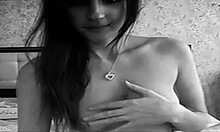 Look at this cute petite brunette with tattoos dancing naked in socks on her bed, teasing us