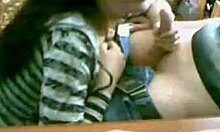 Watch this cute brunette girlfriend secretly sucking her man's cock on webcam, fully clothed yet so naughty.