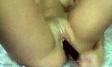 Cute brunette teases shaved pussy with dildo.