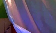 tattooed brunette teasing and taking a shower